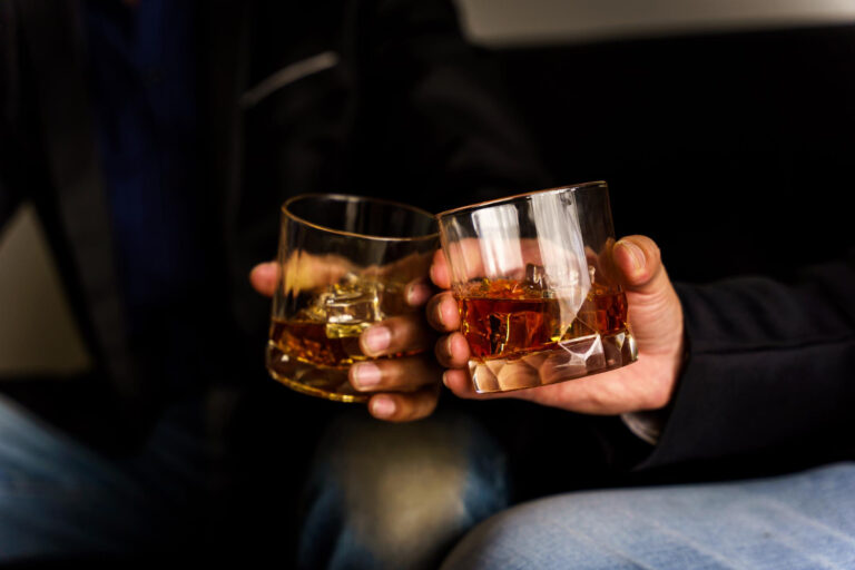 two-hands-clink-glasses-whiskey-wiskey-couch-cozy-bar-drinking-menu (1)